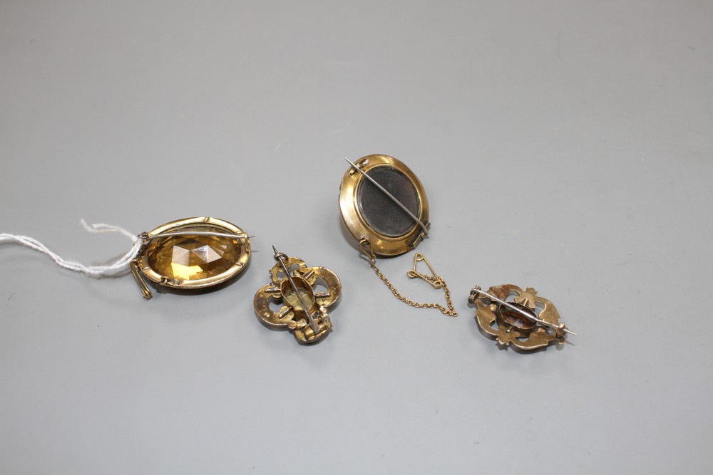 A Victorian yellow metal, enamel, banded agate and seed pearl set mourning brooch and three other brooches,